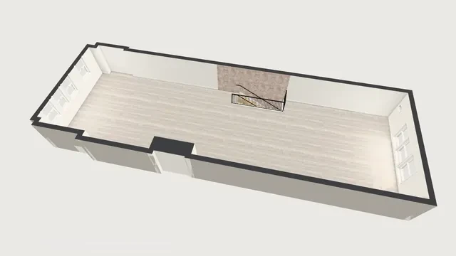 The apartment as one open space, seen from above: no interior walls, a black railing around the stairs, windows at both ends.