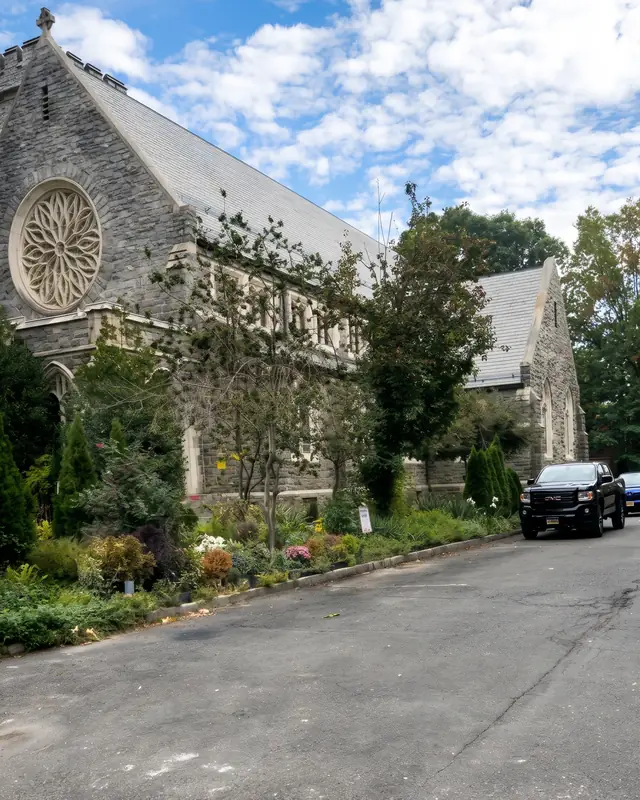 The gray stone Church of the Redeemer and its garden on South Street.