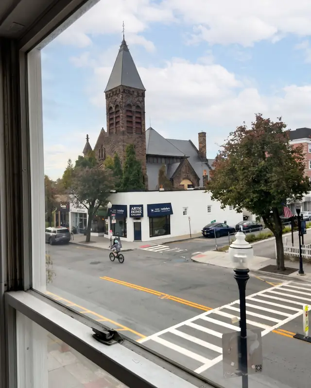 The view from the apartment's front window: a stone church tower and South Street below.